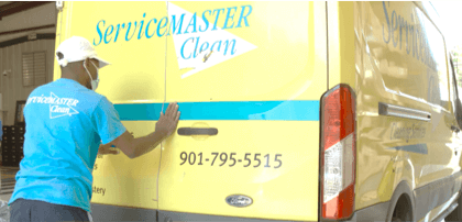 An employee closing the door of a service van