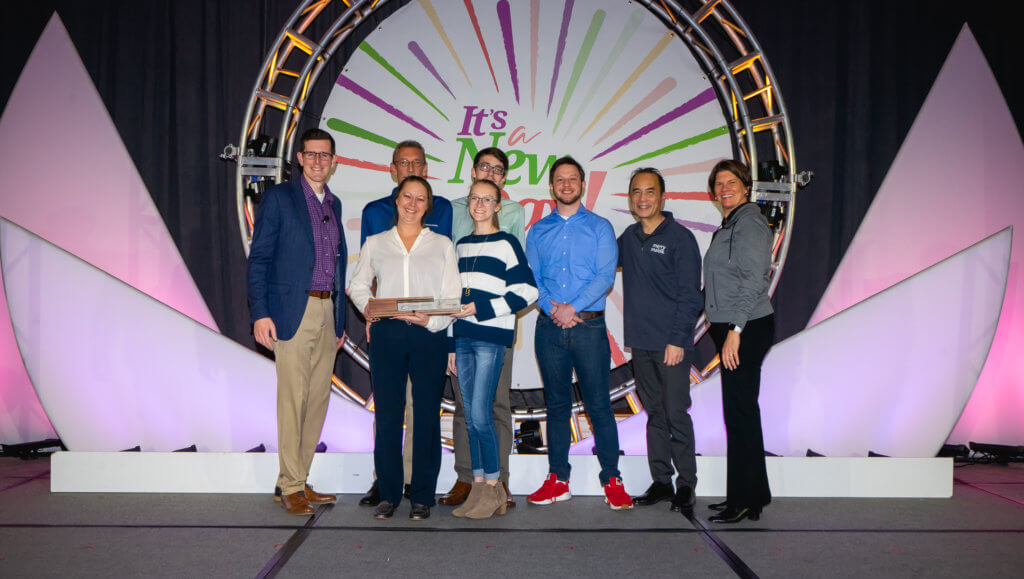 Group of people standing on a presentation stage