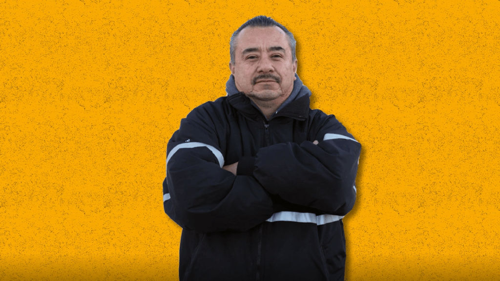 Mover hero Eduardo Martinez standing crossed armed in front of an orange background