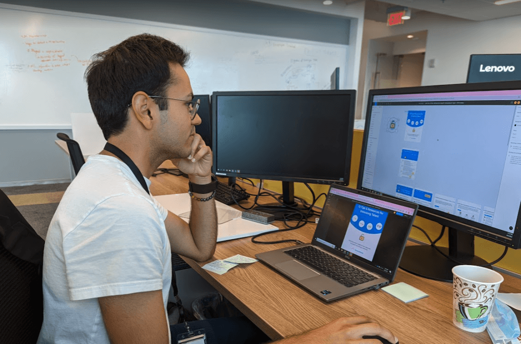 Intern Yugvir Parhar at a desk reading content on his computer screen